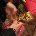 Girl working on doll hair