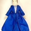 Front of wooden doll in blue dress