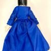 Backside of wooden doll in blue dress