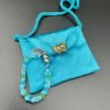 Turquoise purse with butterfly gem and blue and green beaded doll bracelet