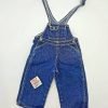 A pair of blue denim overalls with a patch