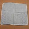 a white cloth napkin folded into four squares