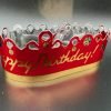 Red metalic crown that says "Happy Birthday"