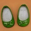 A pair of light green slippers with ribbon bows. The bottom is a hard rubber. No marks.