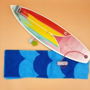 The complete set with all included pieces including Plastic 18 1/2" long "shortboard" style surfboard. Topside (deck) is blue, yellow, pink, and magenta from nose to middle and thick pink striped ombre from middle to tail; overall contrasting white lines and white edges (rails). Nose has on left upright side signature of Tina Hart; middle right of deck has Joss Wave logo. See description and individual pictures for more details.